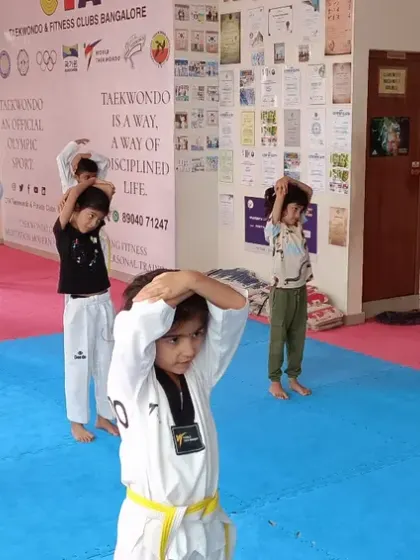 Students doing neck stretches as part of their warm-up.