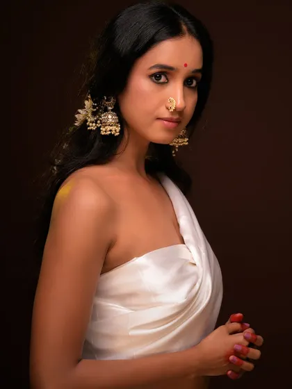 A variation of the white drape portrait, focusing on the intricate jhumka earrings and nose ring.