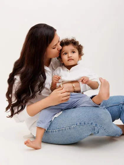 A mother's gentle kiss is a moment of pure tenderness. I focus on capturing these quiet, intimate connections during our family photoshoots.
