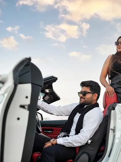 A stylish portrait of the couple with their convertible. This image has a high-fashion, editorial feel, perfect for a glamorous Dubai pre-wedding album.