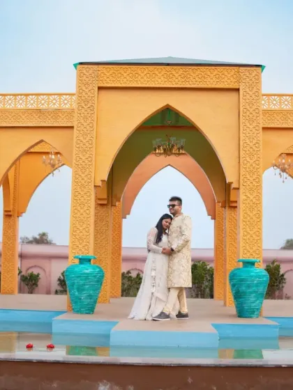 A regal portrait with a touch of tradition. The groom's Indo-western sherwani and the bride's white lehenga create a beautifully coordinated and elegant look.