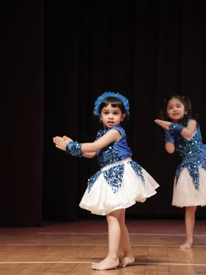 A young performer from the 'Dancing Rockets' group, full of expression and grace.