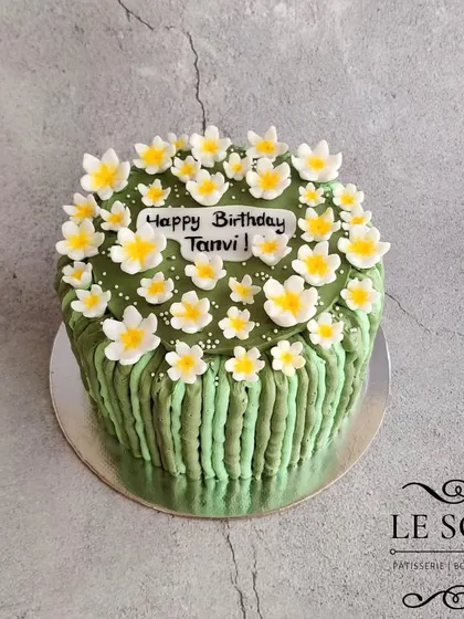 For this cake, the client wanted a buttercream finish instead of fondant. I created this beautiful design with vertical green stripes and a top covered in delicate white flowers.