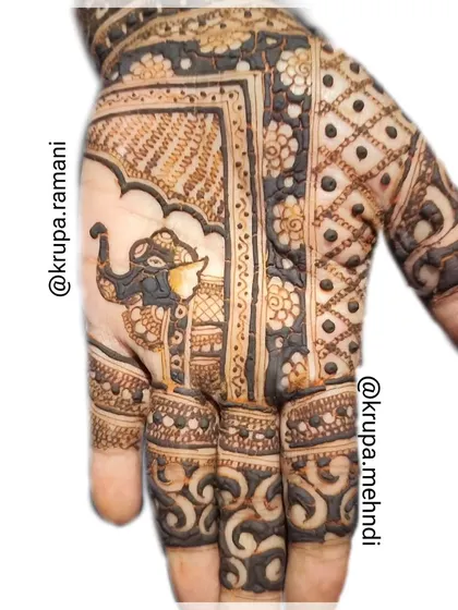 A classic Indian mehndi design with a decorated elephant. The finger details add to the richness of this traditional pattern.