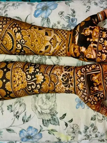 A rich and dense design combining floral patterns with bride and groom figures. The dark stain shows the quality of my henna paste.