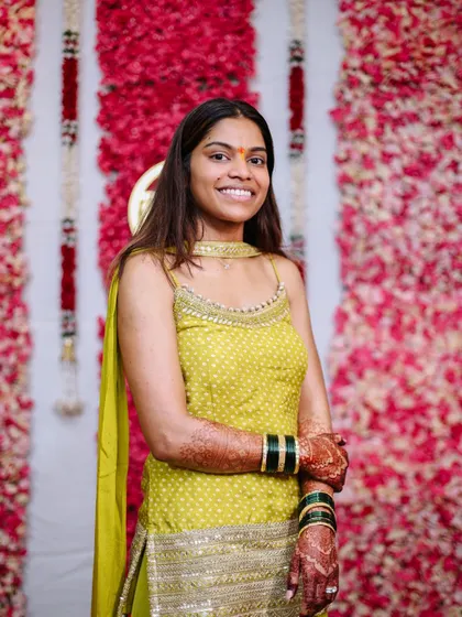 A happy portrait of the bride at her Haldi ceremony.