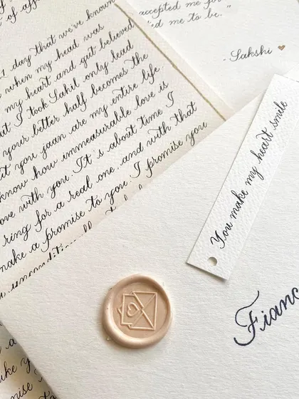 Nothing beats a classic black and white palette. This handwritten letter to a fiancé is minimal and timeless, with a simple name tag and a custom wax seal that says "You make my heart smile."
