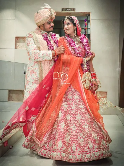 A full-length portrait of the couple in their stunning wedding outfits. I make sure to capture these classic shots that you will cherish for a lifetime, showcasing your complete bridal and groom look.