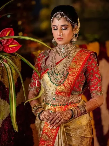 The bride in a moment of quiet reflection, her beautifully stained hands clasped.