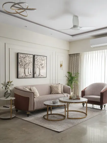 The centerpiece of the 'Elysian Enclave' living room is this sumptuous curved sofa. I used soft hues, classical wall moulding, and wall washers to create a serene ambiance that feels both timeless and contemporary.