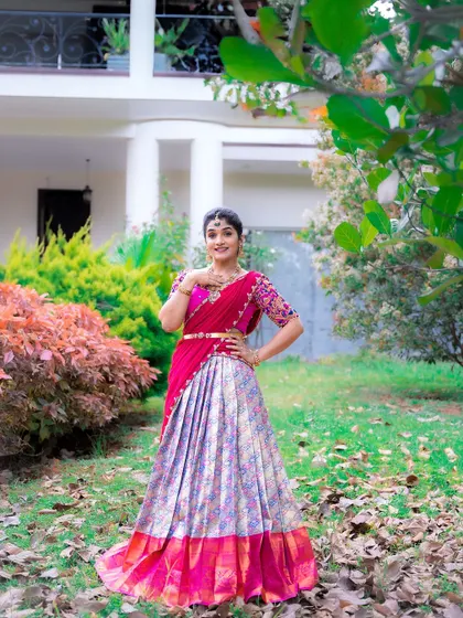 A full-length view of a pink and silver-grey brocade half saree, an elegant and unique color combination.