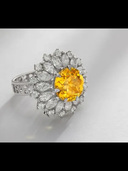 A floral-inspired statement ring featuring a vibrant round yellow gemstone at its center, encircled by marquise-cut diamonds. This image showcases my ability to balance complex designs and capture the unique character of colored gemstones for catalogue and campaign use.