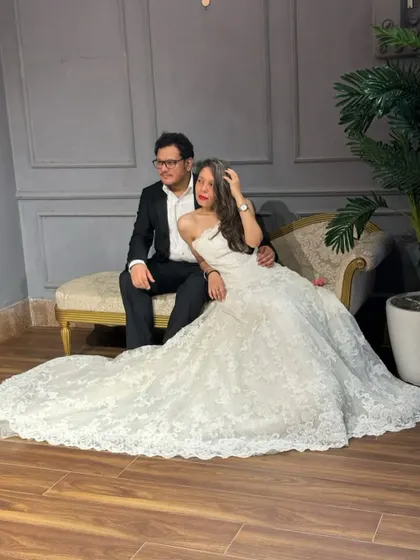 Make your fairytale dreams come true. This classic pre-wedding shoot look pairs a stunning white lace ball gown with a sharp black suit for a timeless and romantic vibe.