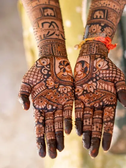 Sweet moments wrapped in mehendi. This royal bridal look features portraits of the couple, surrounded by elephants and intricate patterns.