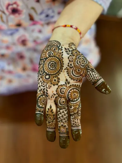 A dense and intricate design filled with various traditional mandala and paisley elements.