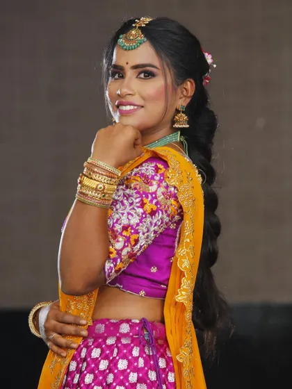 A side profile showing off the braided hairstyle and the glowing makeup. This is a great look for a wedding guest or bridesmaid.