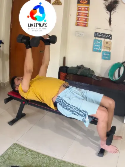 A client performs a dumbbell bench press, a fundamental exercise for building chest, shoulder, and tricep strength. We focus on controlled movements to maximize muscle engagement.