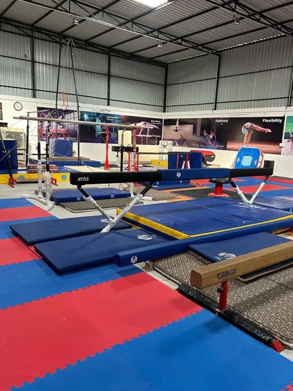 A view of our balance beam and floor area. We have professional-grade equipment and ample space for our athletes to train effectively.