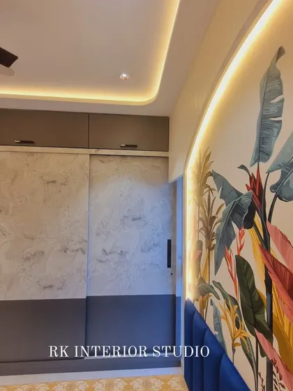 This bedroom features a stunning tropical wallpaper accent wall and a sliding wardrobe with a modern two-tone design.