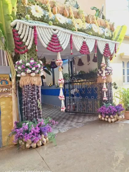The same beautiful entrance seen in bright daylight, showing the natural colors of the flowers and leaves.