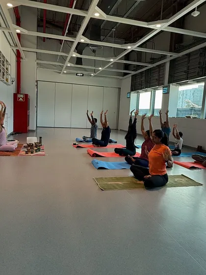 A seated warm-up with arms overhead to lengthen the spine. This is how we begin many of our corporate sessions, by creating space in the body.