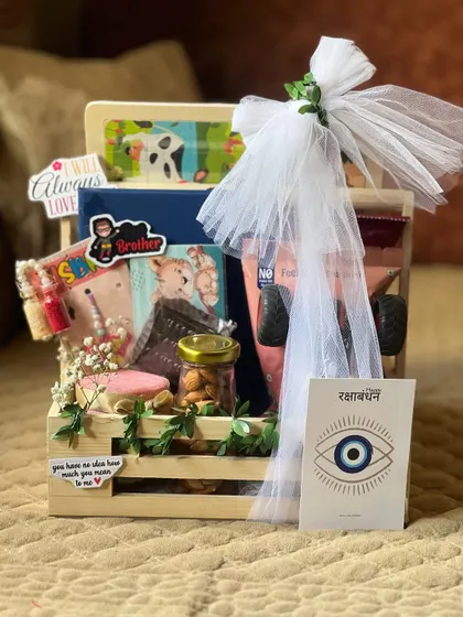 A charming wooden crate hamper for a brother, including a fun puzzle, snacks, and a protective evil eye card.