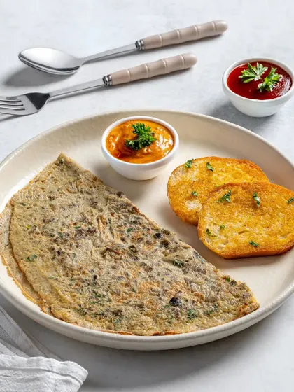 A simple omelette served with two different sauces and toasted bread.