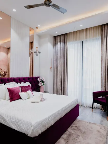 A wider shot of the "Barbie" bedroom, showing the dressing table area and the large window that fills the room with light. The plush rug adds another layer of comfort.