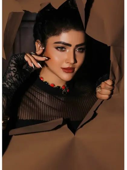 A creative and conceptual beauty shot, with the model peering through torn paper. This artistic approach is perfect for an editorial or a high-fashion makeup campaign.