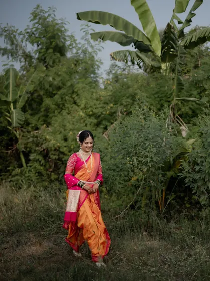 A candid portrait of the bride walking through a green, natural landscape, looking serene and beautiful.