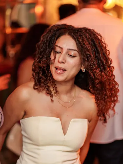 The dance floor is a place of expression. A guest with amazing curls feeling the rhythm and the energy of the room.