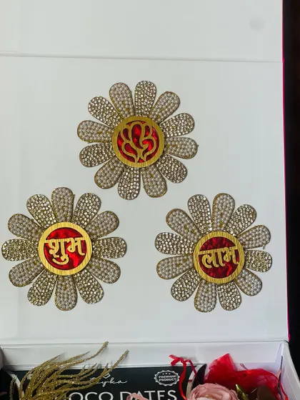 The lid of a premium white gift box decorated with 'Shubh Labh' floral medallions, perfect for Diwali.