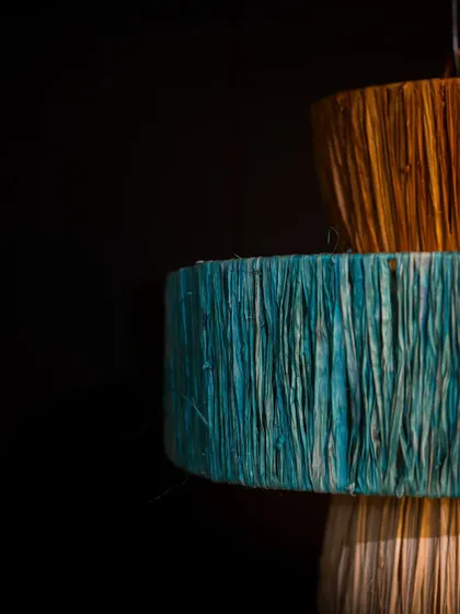 A detailed shot of the colored fibers. The rich, dyed hues of the material are shown here, highlighting the beautiful imperfections and tactile quality of the lampshade.