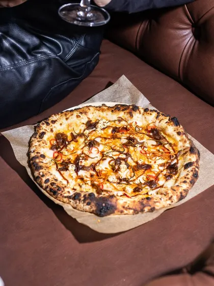 Weekends call for fresh pies. This Caramelised Onion & Feta pizza sits on a comfy leather couch, proving that my food is perfect for a relaxed, cozy night in.