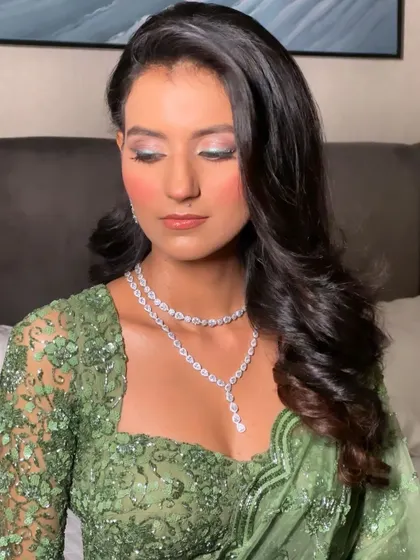 Classic, soft waves styled with a center part. This is a timeless and elegant look that never goes out of style, perfect for an engagement or reception.