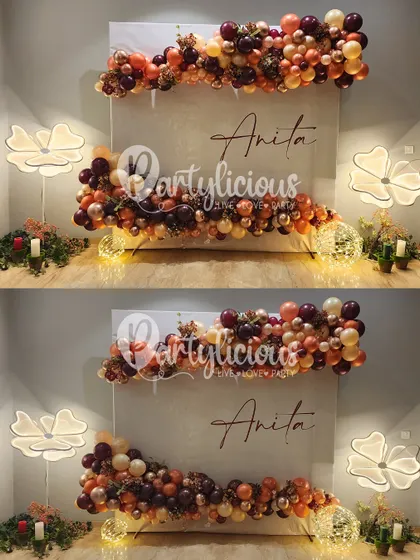 A stunning personalized backdrop for Anita's birthday, featuring a beautiful balloon garland in rich autumnal colors.