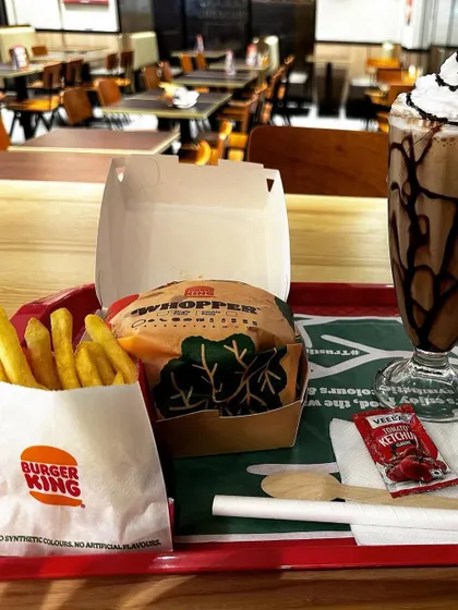 A satisfying meal tray from Burger King, complete with a Whopper, fries, and a shake. It's the perfect fuel for the road ahead.