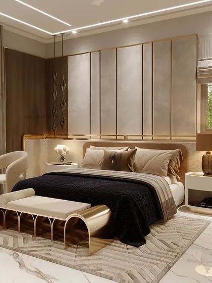 We designed this luxurious bedroom with a balanced color palette and a touch of gold. Finishes in the furniture and textures in the wall paneling create depth and interest in this contemporary, high-end space.