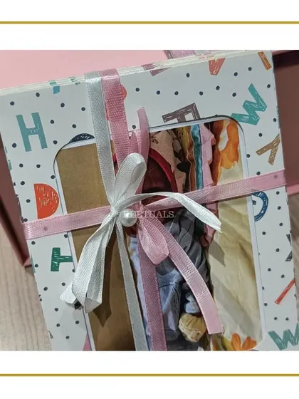 A beautifully packaged baby album, part of a larger gift set for a newborn.