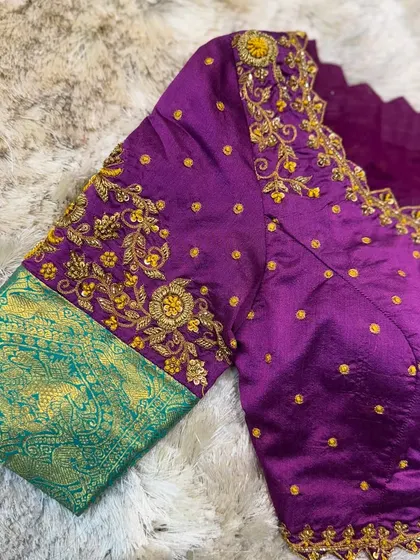 The front view of the purple and green blouse, showcasing the scalloped neckline and butti work.