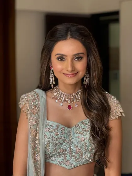 A perfect look for an engagement or reception. I styled this bride's hair in soft, face-framing waves to complement her pastel lehenga and radiant makeup, creating an effortlessly elegant appearance.