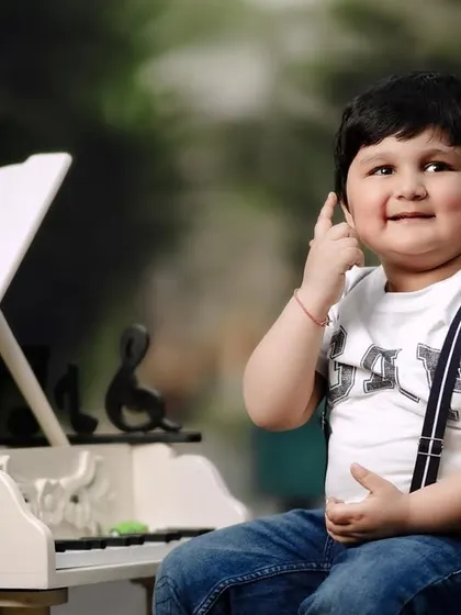 A happy three-year-old at his piano. It's wonderful to see how children's personalities shine during these fun, interactive photoshoots.