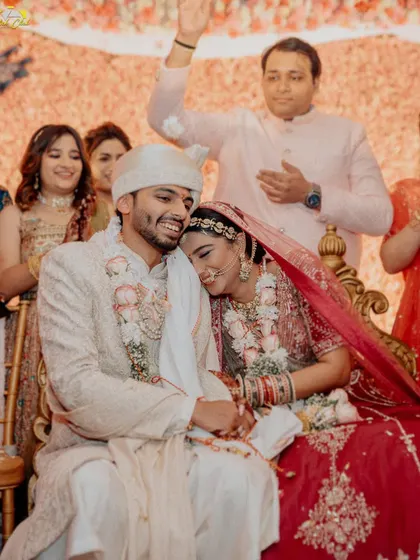 A tender moment post-ceremony. The bride rests her head on the groom's shoulder, a picture of comfort, love, and the quiet beginning of their new life together.