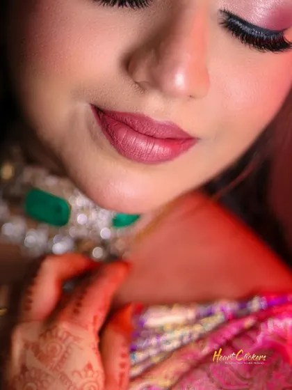 A macro shot focusing on the bride's soft smile and beautiful makeup. Every detail contributes to the overall bridal look.