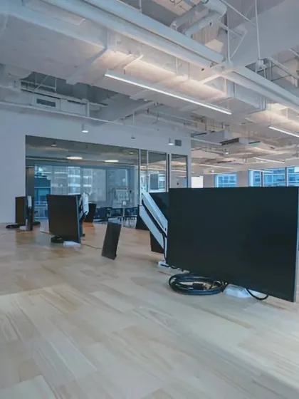 A close-up of the light wood desk surfaces and the clean, organized cable management solutions we implement to maintain a tidy and functional workspace.