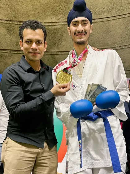 My coach presenting me with the Gold medal from the India Open. A special moment between a guru and his student.