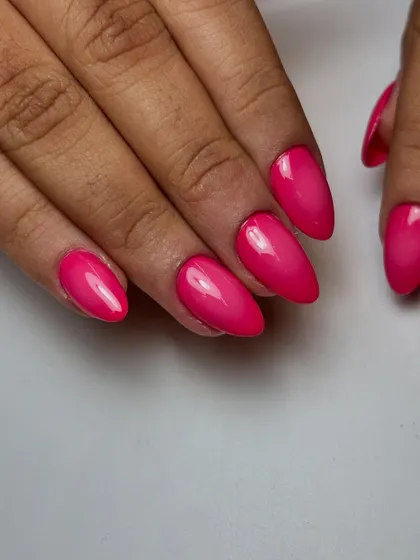 Another angle of the vibrant pink airbrushed ombre nails. Notice the smooth transition from the lighter center to the darker edges, creating a beautiful depth on the almond shaped extensions.