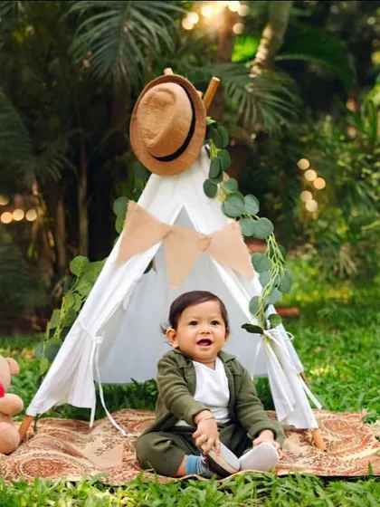 An outdoor milestone session with a cute teepee setup. This is perfect for adventurous babies who are sitting up and interacting with the world.