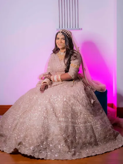 Another shot of Palak's stunning bridal look. The soft lighting and her happy expression make this a picture-perfect moment.