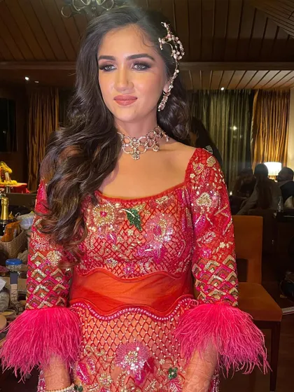 The bride looks radiant and ready for a night of dancing with her stunning outfit and perfectly styled waves.